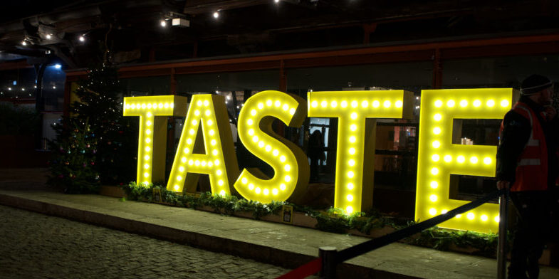 A lit-up sign reading Taste
